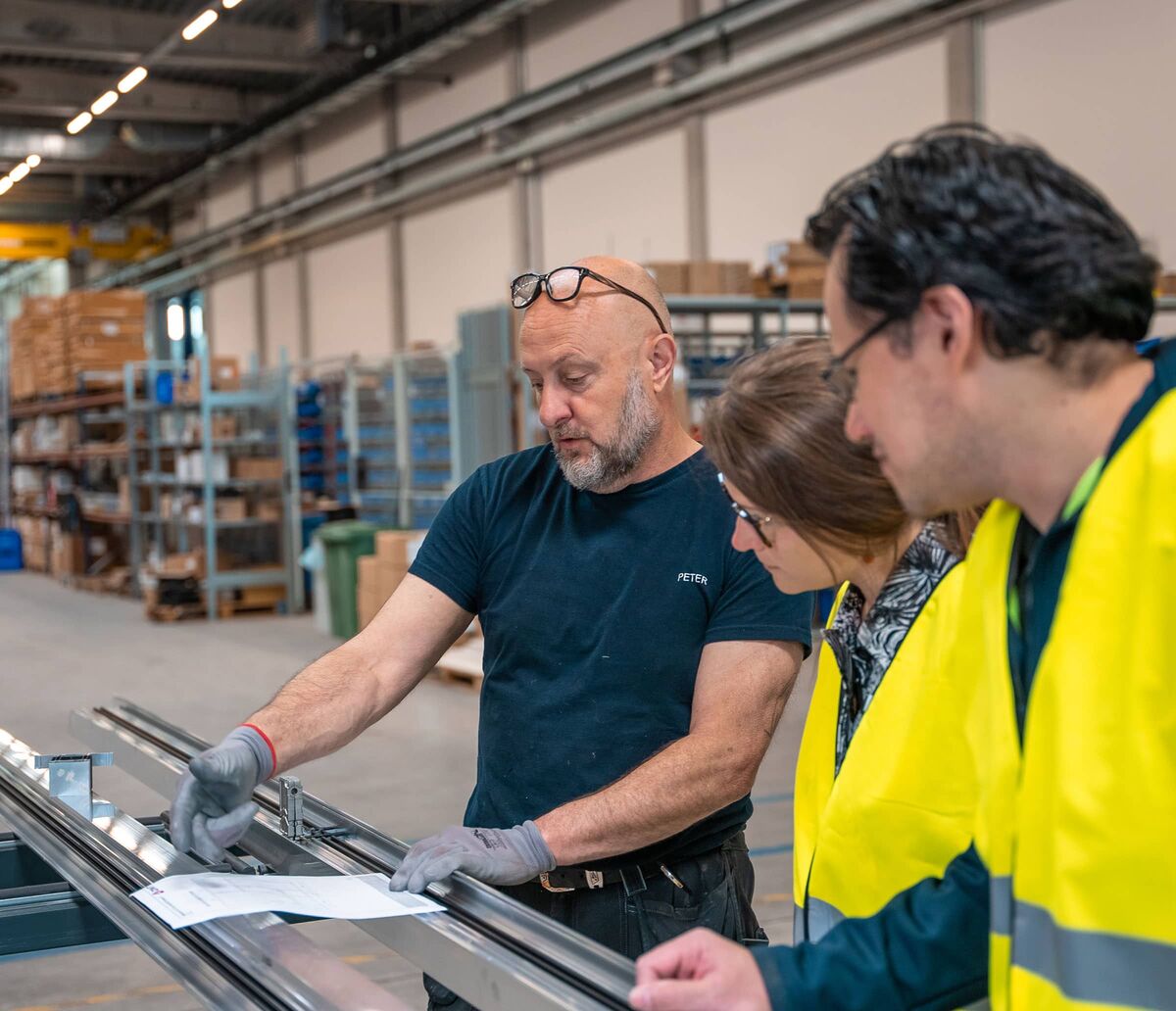 Fabricator discussing order details with other building professionals.